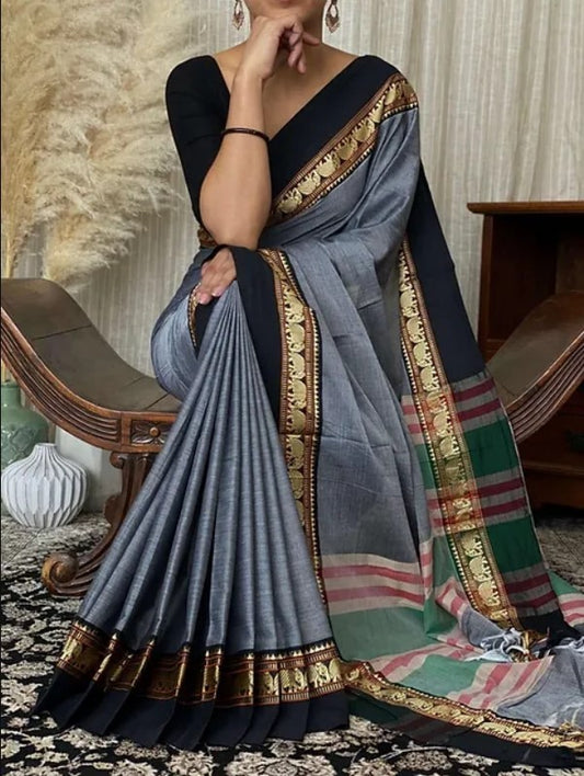 A woman modeling a Narayanpeth Mercerised Cotton Saree with a traditional border and a shine of silk threads, primarily in gray, black, and multicolor tones.