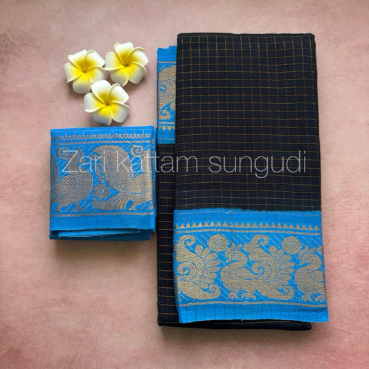 Black and blue saree with floral design on a pink background