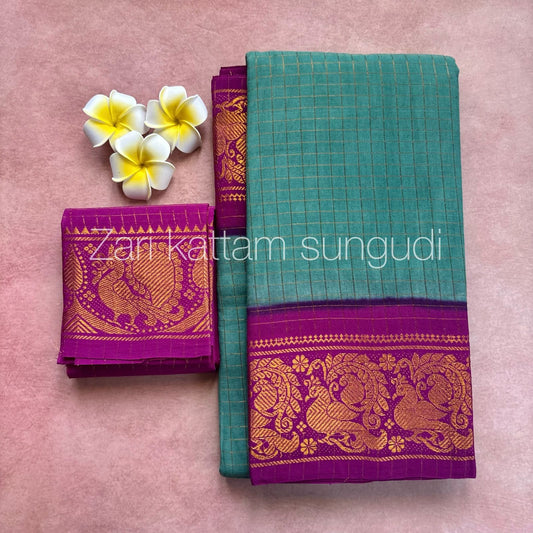 Two traditional sarees with zari patterns on a pink background, accompanied by white flowers.