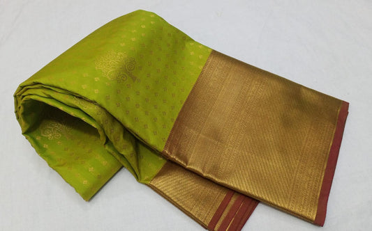 Green and gold saree with a plain background