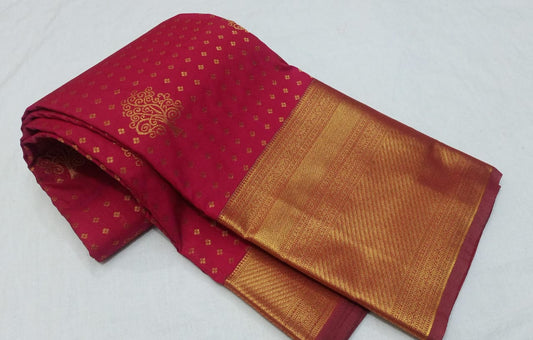 Red and gold saree with a decorative pattern on a white background