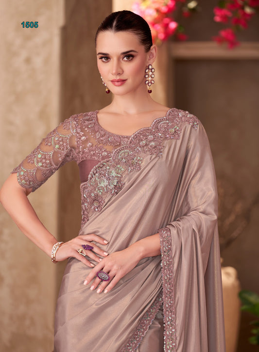 Woman wearing a beige saree with intricate embroidery in a decorative setting