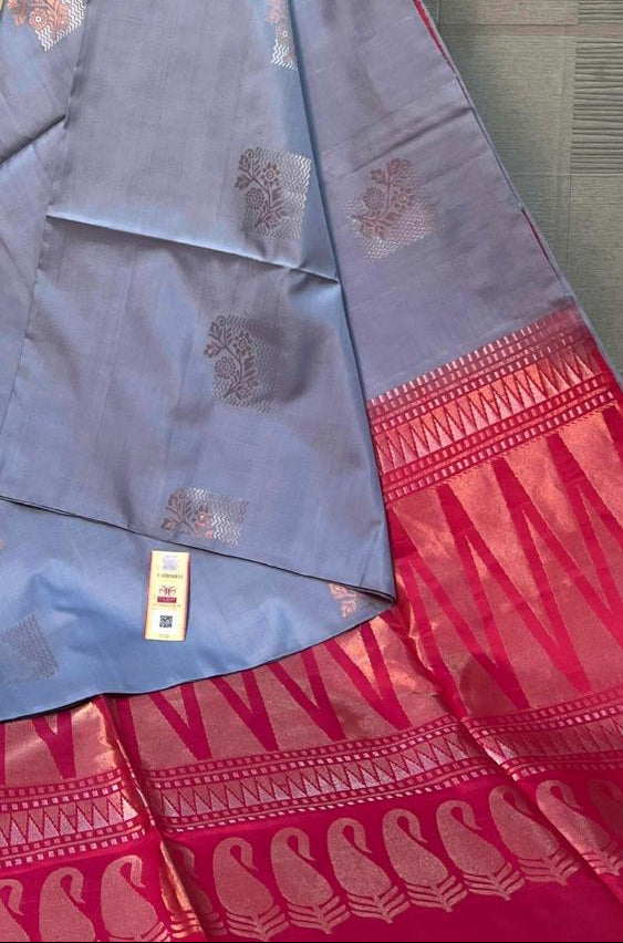 Blue and red saree with a brand logo in the background