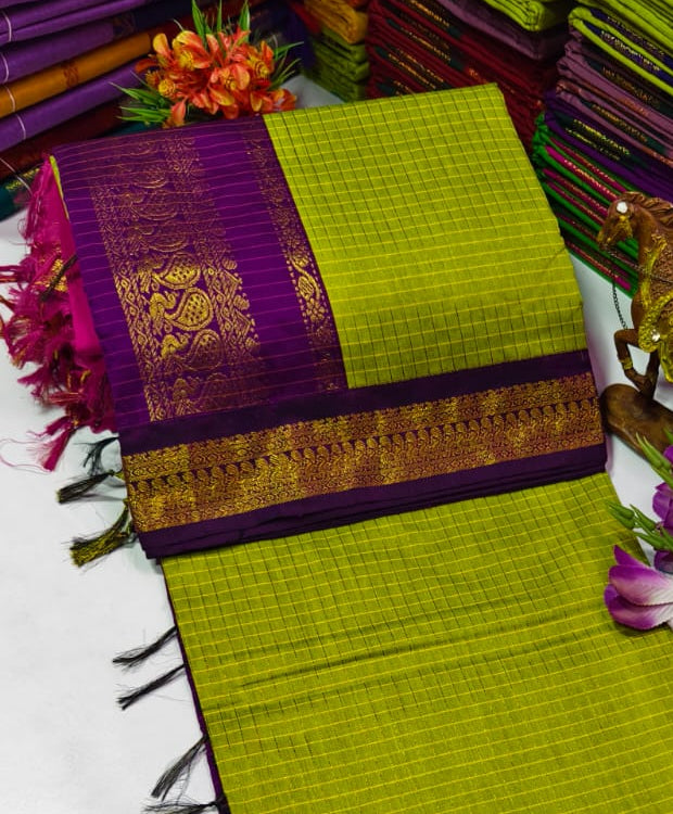 Green and purple saree with floral decorations on a white background