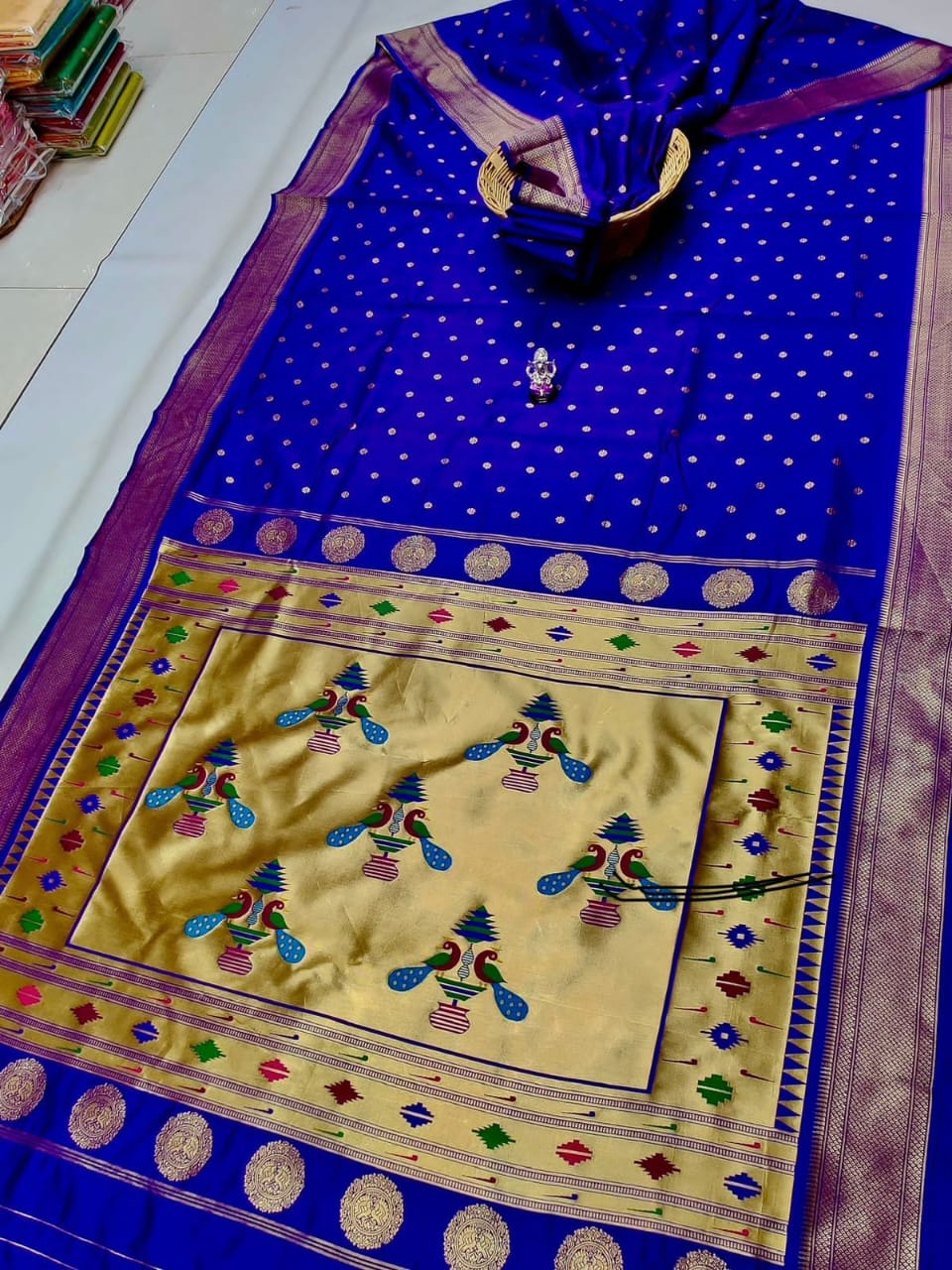 Blue and yellow saree with intricate patterns on a white background