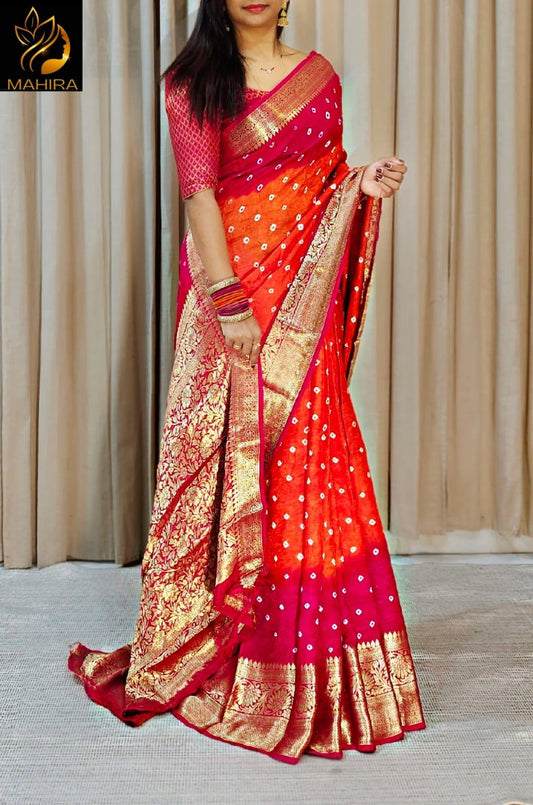 Red saree with gold and pink patterns on a white background