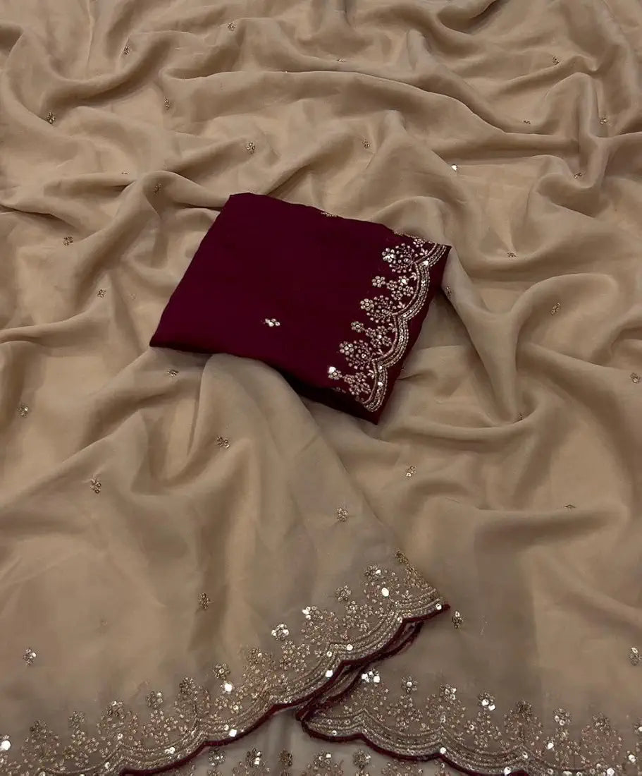 Red fabric with silver embroidery on a beige fabric background
