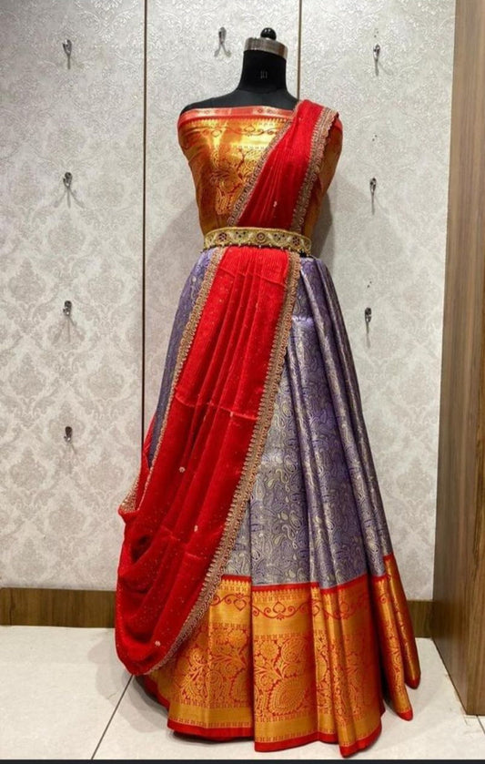 A Banarasi Pattu lehenga in purple and red with a red dupatta and an unstitched blouse piece, displayed on a mannequin.