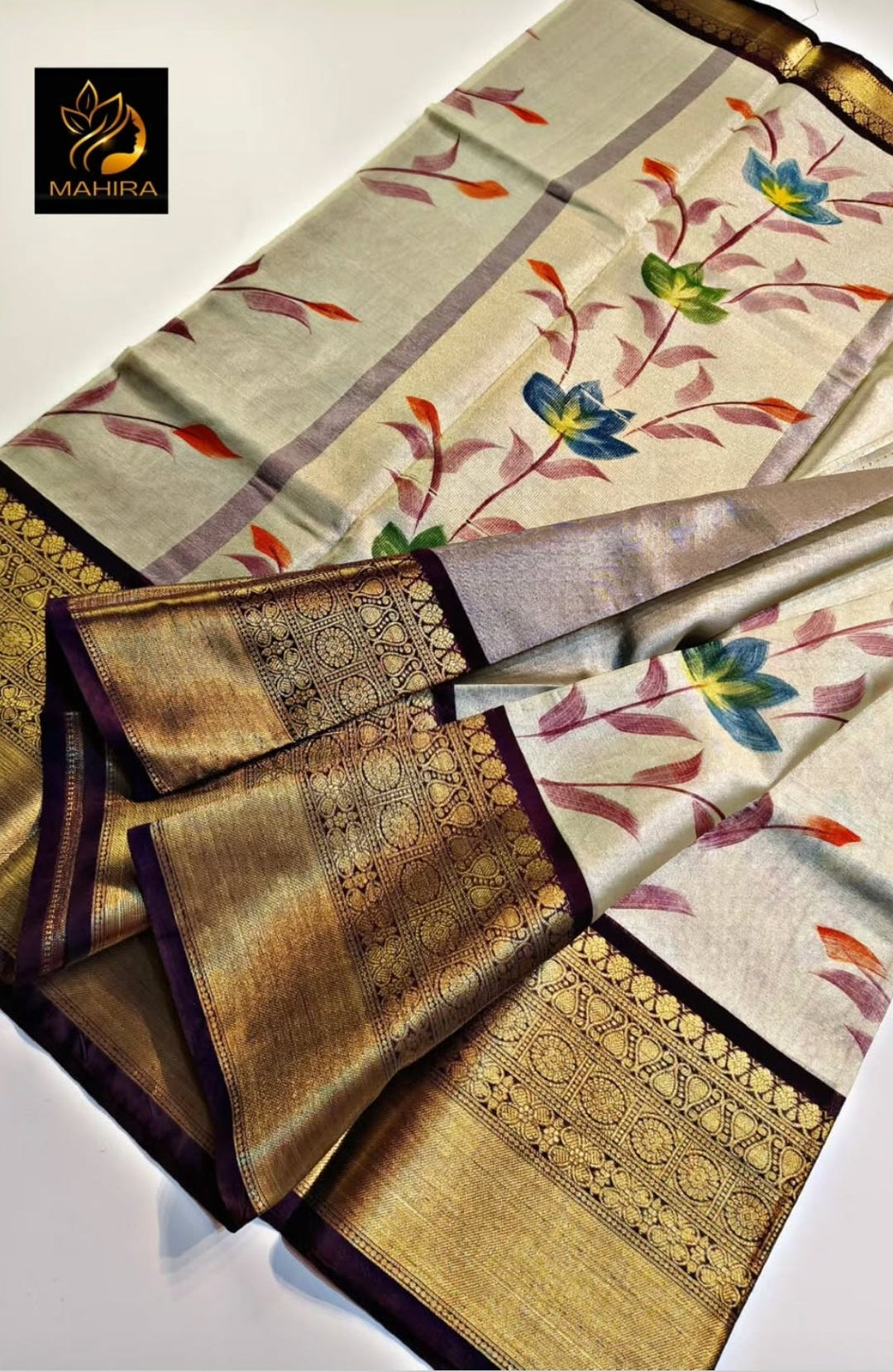 Saree with floral patterns and gold accents on a light background