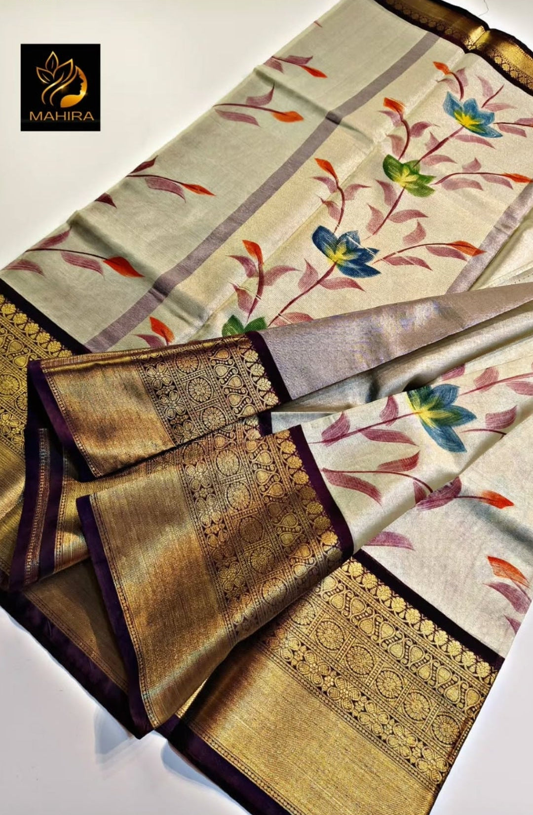 Saree with floral patterns and gold accents on a light background