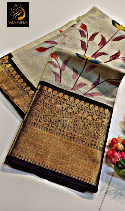 Decorative saree with floral patterns on a white surface, featuring the brand 'Mahira'.
