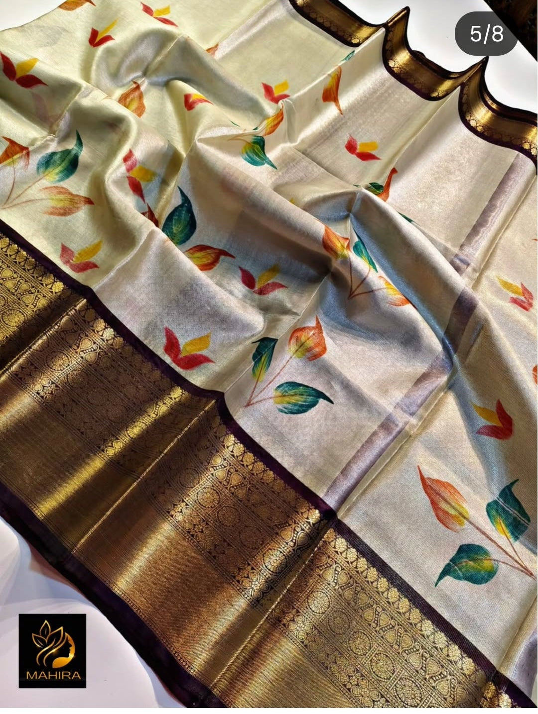 Traditional fabric with colorful patterns on a gold border, displayed on Instagram.