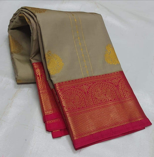 A soft beige color saree with luxurious copper zari and maroon borders, and mango motifs.