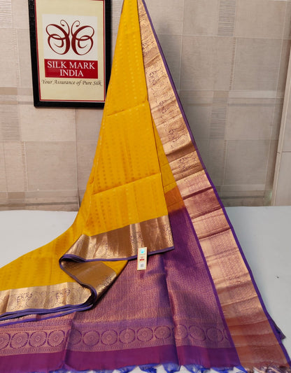 Yellow and purple saree with a brand logo in the background