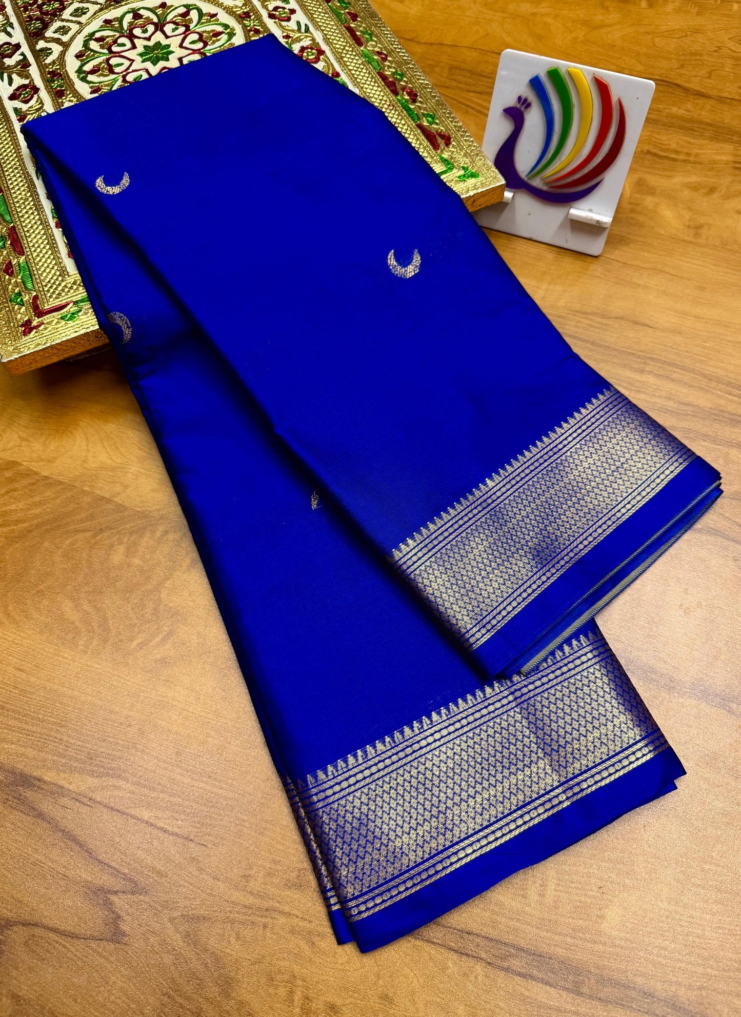 Blue saree with white patterns on a wooden surface