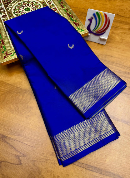 Blue saree with white patterns on a wooden surface