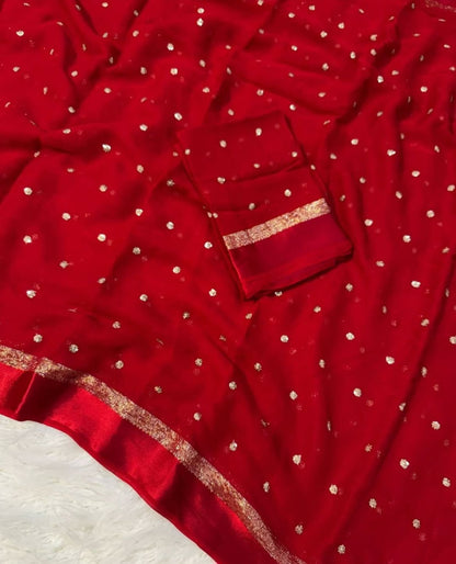 Red fabric with white polka dots and gold trim on a white background
