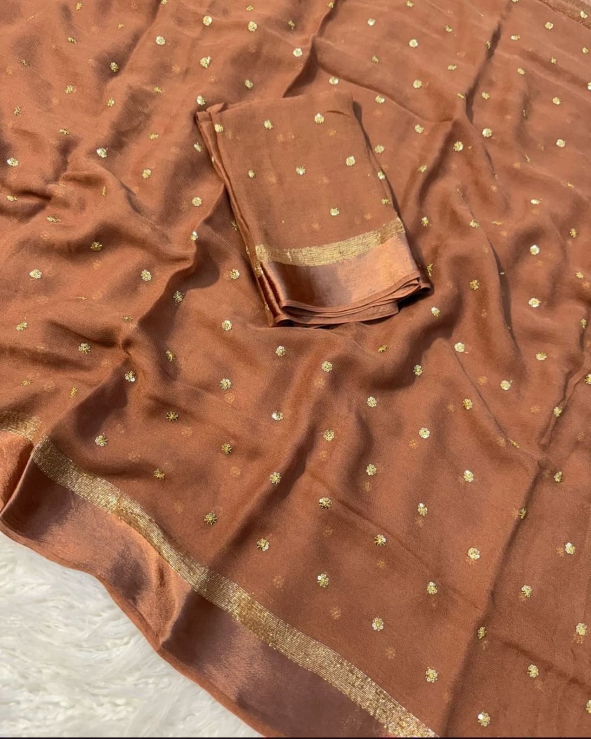 Brown fabric with gold patterns and border