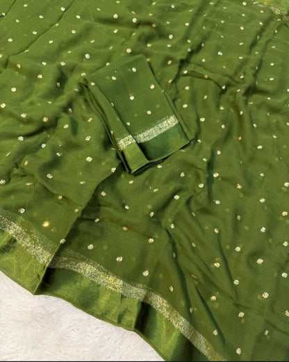 Green fabric with gold polka dots and border on a white background