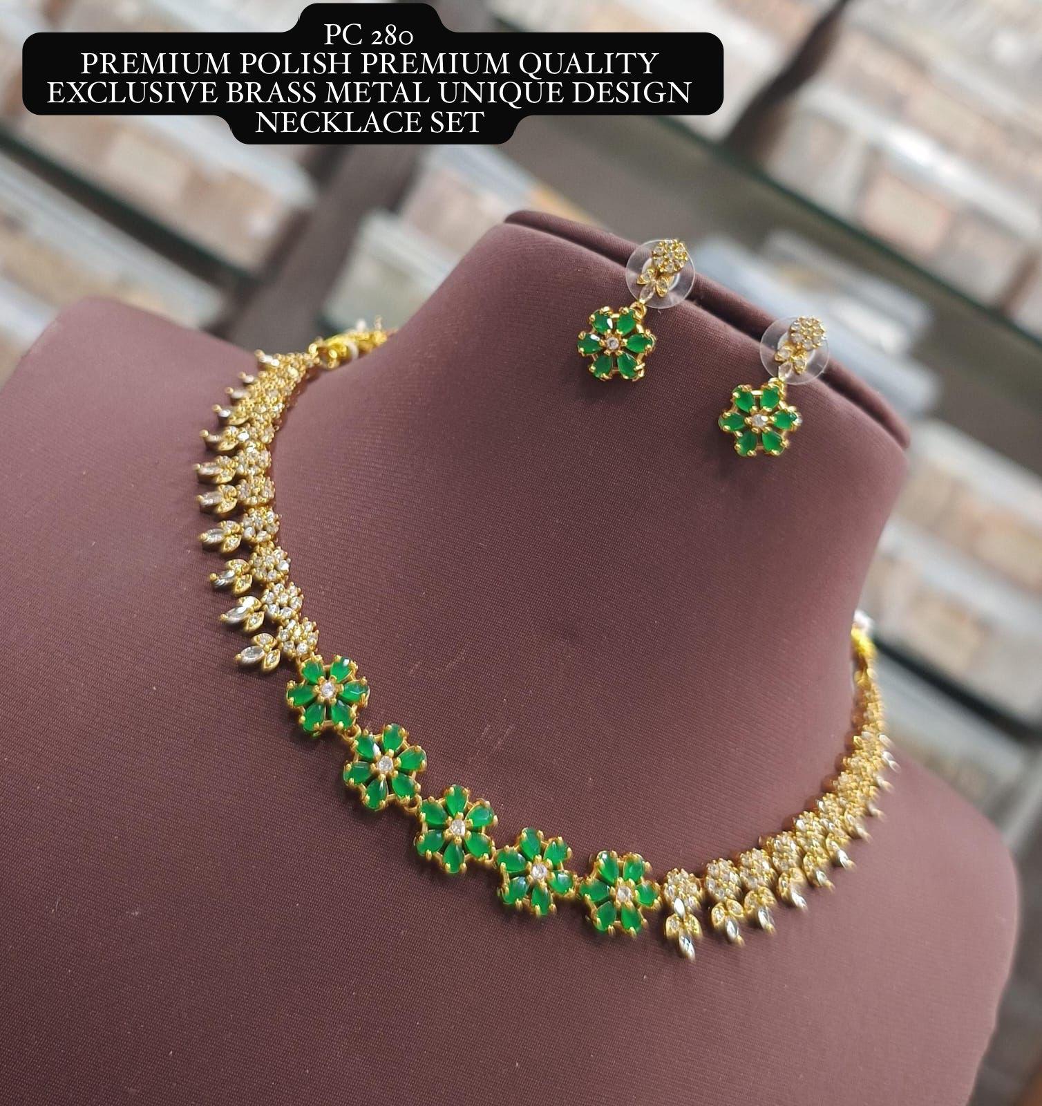 Gold and green necklace set on a mannequin bust with text overlay.