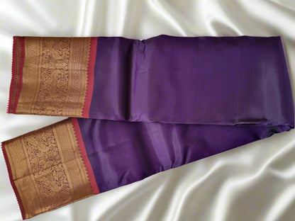Purple saree with gold and red border on a white background