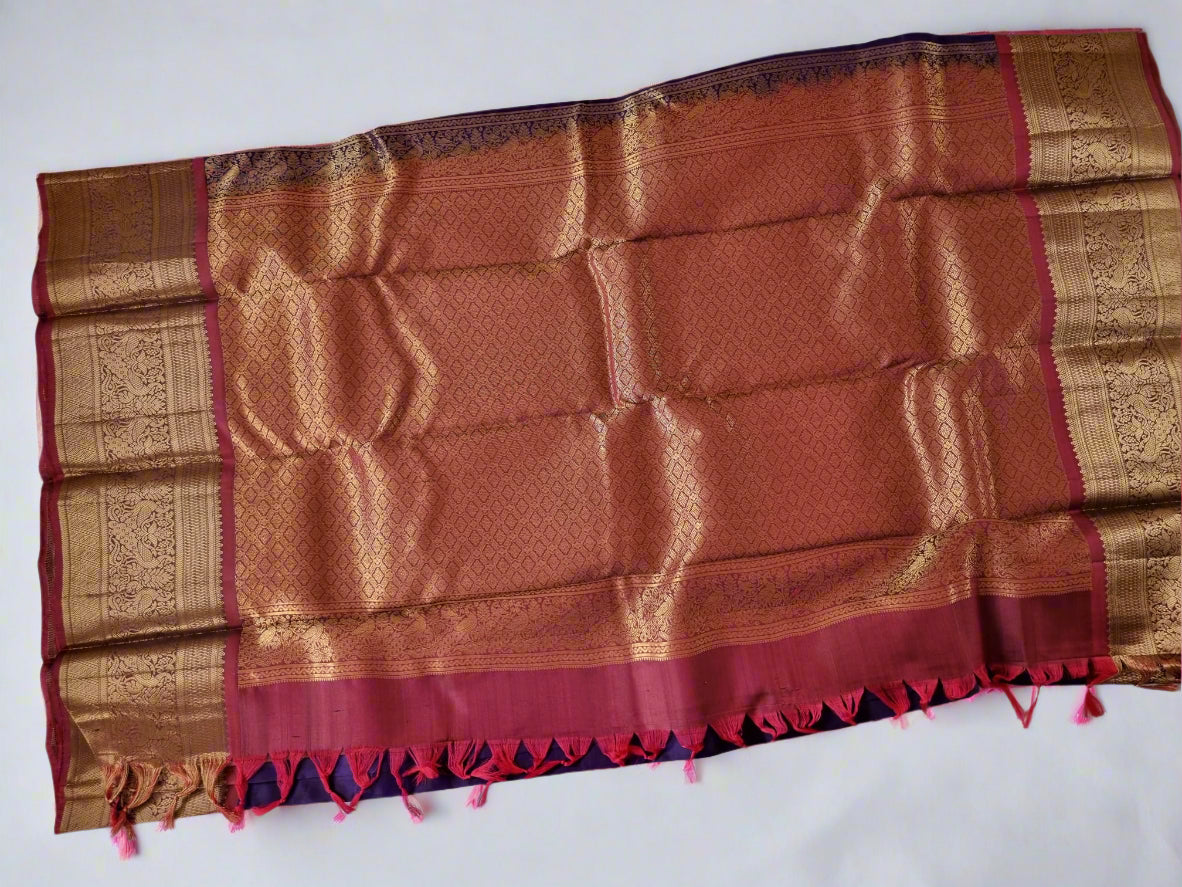 Brown and gold patterned fabric with red accents on a white background