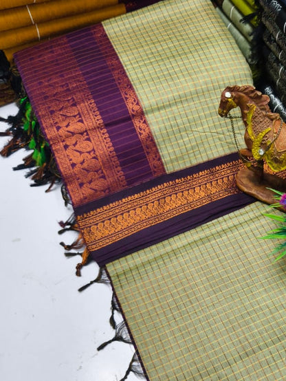 Stack of colorful woven fabrics with a decorative item on a white surface